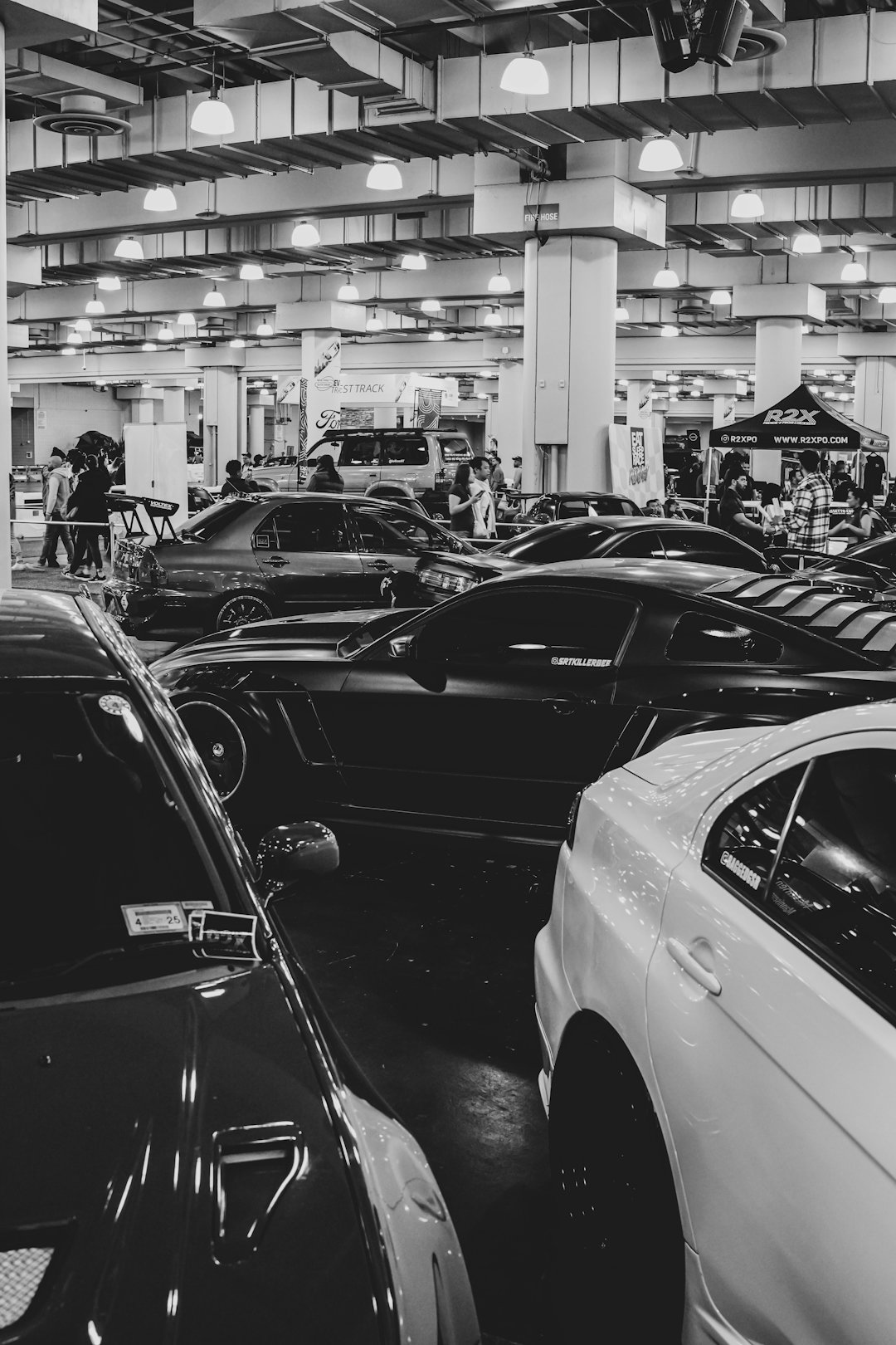 a black and white photo of cars in a garage
